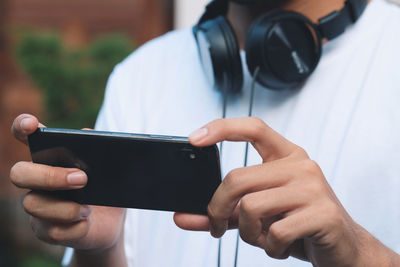 Midsection of person using mobile phone