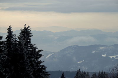 Scenic view of mountains against sky during foggy weather