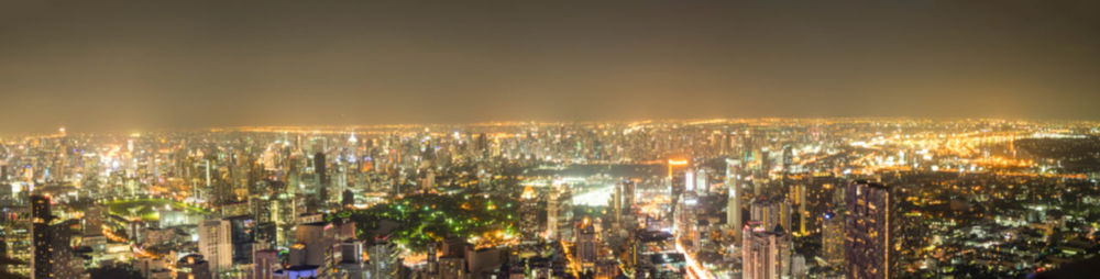 Panoramic view of illuminated buildings against sky at night