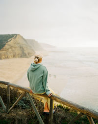 Rear view of woman watching the ocean