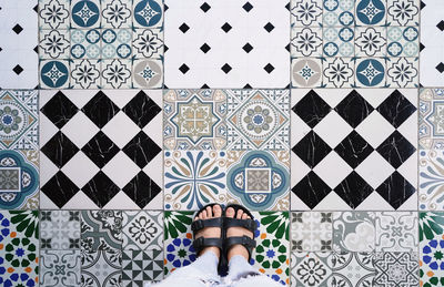 Low section of woman standing on tiled floor