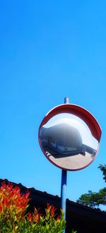 Low angle view of electric lamp against clear blue sky