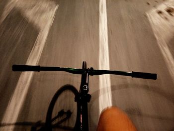 Close-up of bicycle riding on road