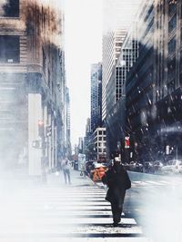 Man walking on road in city