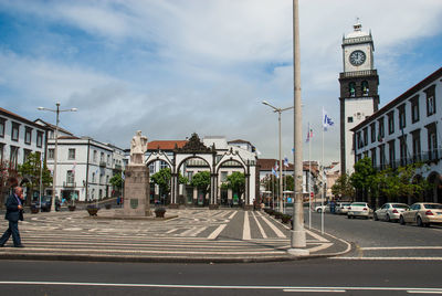 Road by building against sky in city