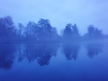 Scenic view of lake against blue sky