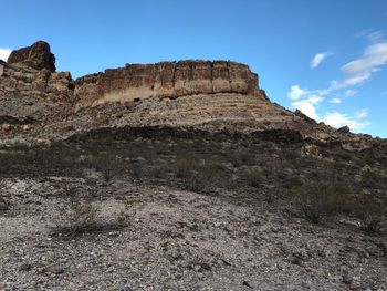 Low angle view of rock formations against sky