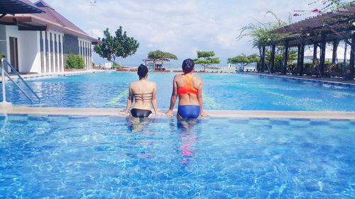 Rear view of women in swimming pool