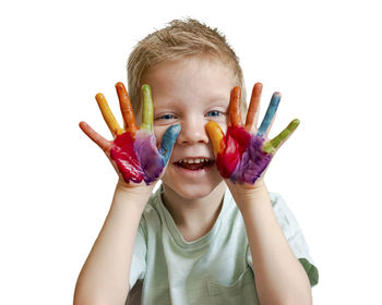 Portrait of smiling boy against colored background