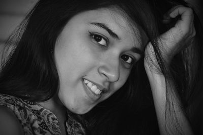 Close-up portrait of smiling young woman