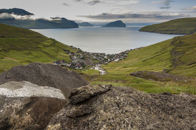 Scenic view of sea and mountains against sky
