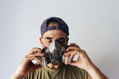 Portrait of airbrush painter putting on his protective mask.