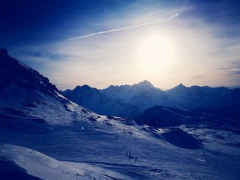 Scenic view of mountains against blue sky