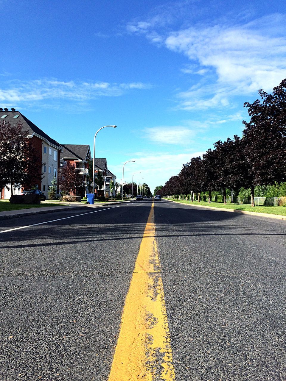 the way forward, diminishing perspective, road marking, vanishing point, transportation, building exterior, road, architecture, sky, built structure, street, asphalt, city, surface level, empty, cloud - sky, empty road, cloud, blue, long