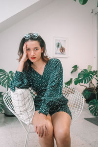 Portrait of young woman sitting at home