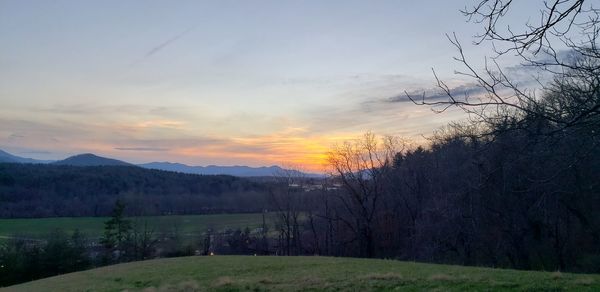 Scenic view of field against sky during sunset