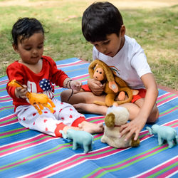 Two happy boys in society park, happy asian brothers who are smiling happily together. brothers play