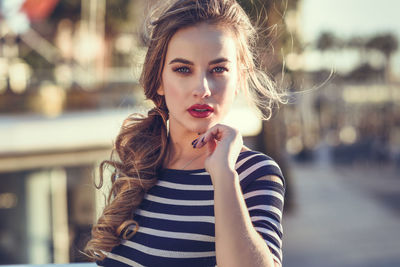 Portrait of young woman standing outdoors