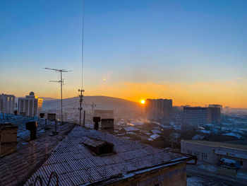 High angle view of buildings against sky during sunset