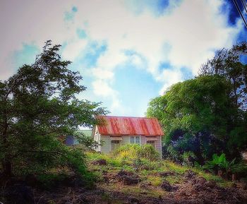 Houses against cloudy sky