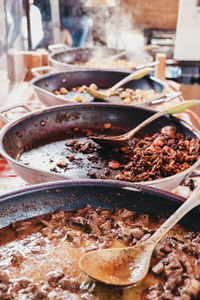 Variety of take away curries on sale of a street food market, selective focus.