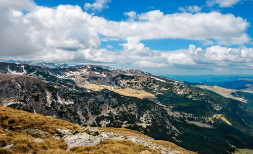 Scenic view of mountains against cloudy sky