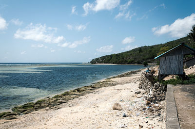 View of hut at sea against sky