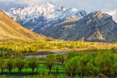 Scenic view of lake and mountains against sky