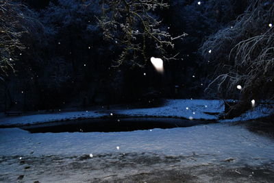 Scenic view of frozen lake against sky at night