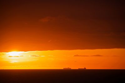 Scenic view of sea against romantic sky at sunset