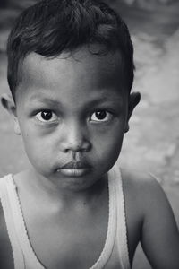 Close-up portrait of cute boy standing on road