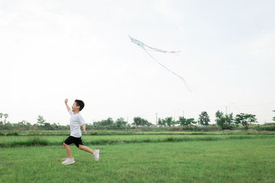 Full length of a boy playing in field