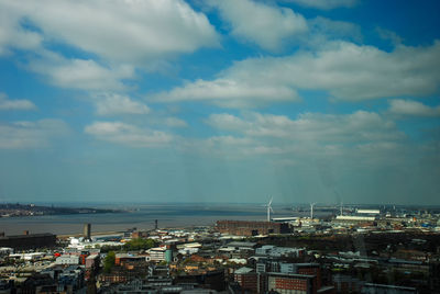 High angle view of townscape by sea against sky