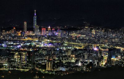High angle view of illuminated buildings in city at night