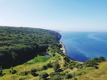 High angle view of trees and sea against sky