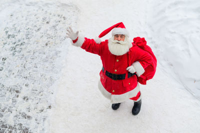 Man with arms outstretched in snow