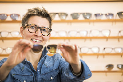 Portrait of smiling woman standing in store