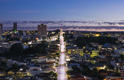 High angle view of illuminated buildings in city at night