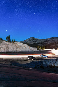 Scenic view of snowcapped mountains against sky at night