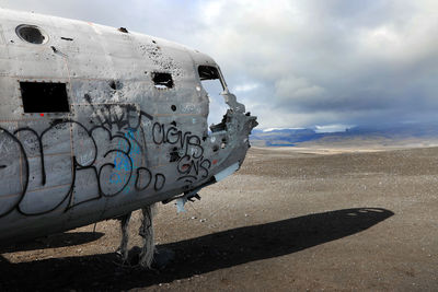 View of abandoned airplane on beach