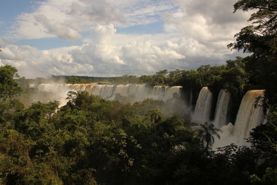 Panoramic view of waterfall against sky