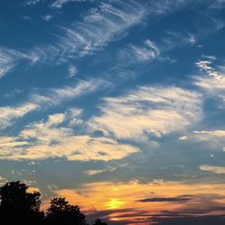 Low angle view of cloudy sky at sunset