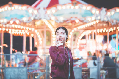 Young woman standing at amusement park