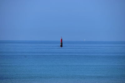 Scenic view of sea against clear blue sky