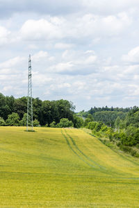 Scenic view of golf course against sky