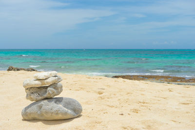 Rocks on beach against sky