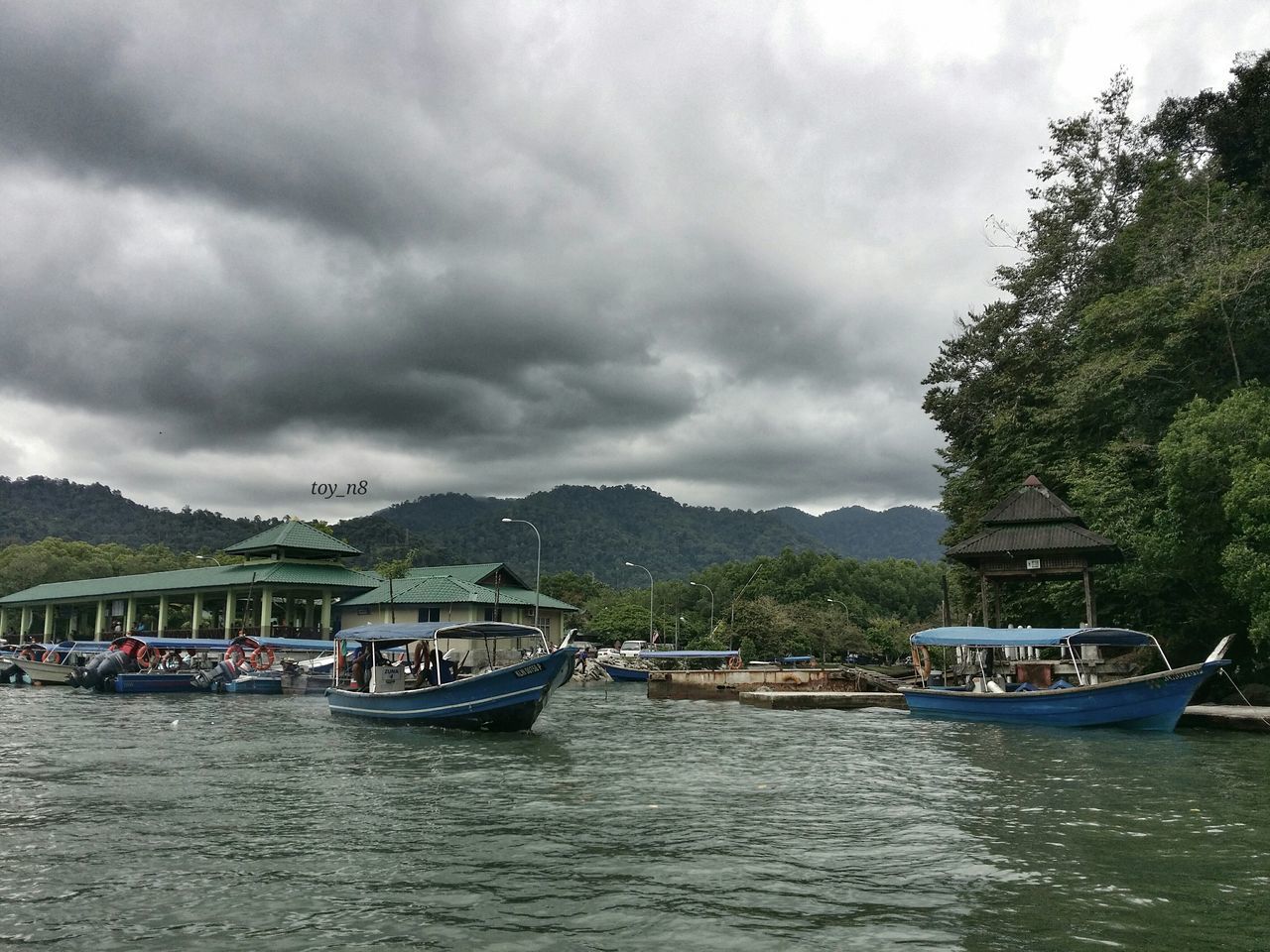 sky, water, cloud - sky, cloudy, waterfront, architecture, nautical vessel, built structure, building exterior, mountain, cloud, transportation, boat, tree, overcast, river, mode of transport, nature, scenics, house