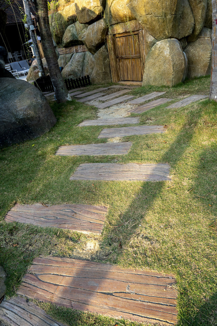 HIGH ANGLE VIEW OF STONE WALL WITH SUNLIGHT