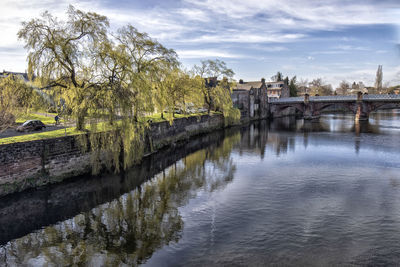 Arch bridge over river against sky