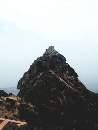 Low angle view of rock on mountain against sky